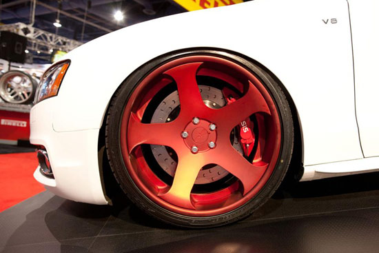 The car has a set of incredible candy red Rotiform NUE concave wheels